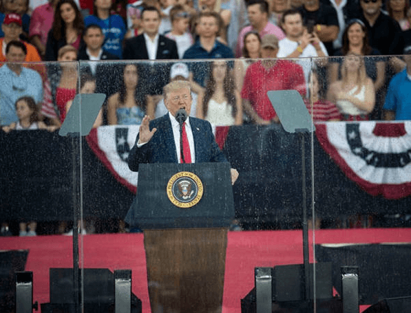 Real scene photo of a politician using a teleprompter on the podium